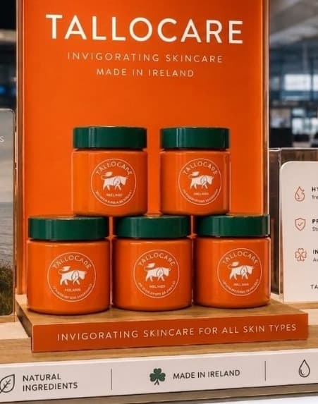 TalloCare orange jars on wooden duty-free display